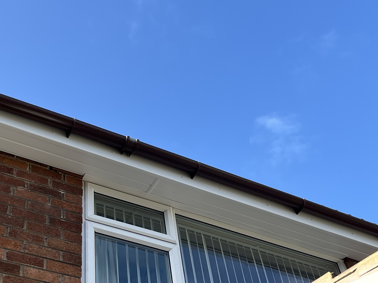 White fascias and soffits cleaned back to bright white against a blue sky